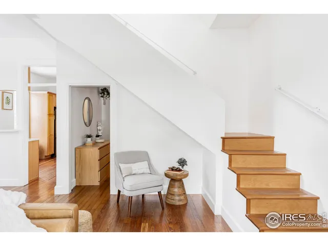 a living room with furniture and a painting