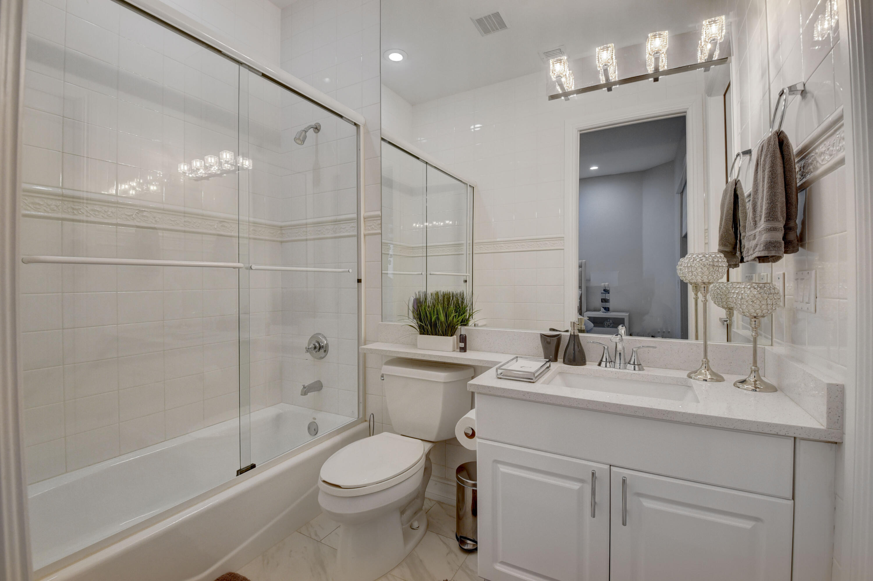 921 Osceola Drive, Unit 4 Boca Raton, FL 33432 - Photo 16 of 46 a bathroom with a sink a toilet and shower
