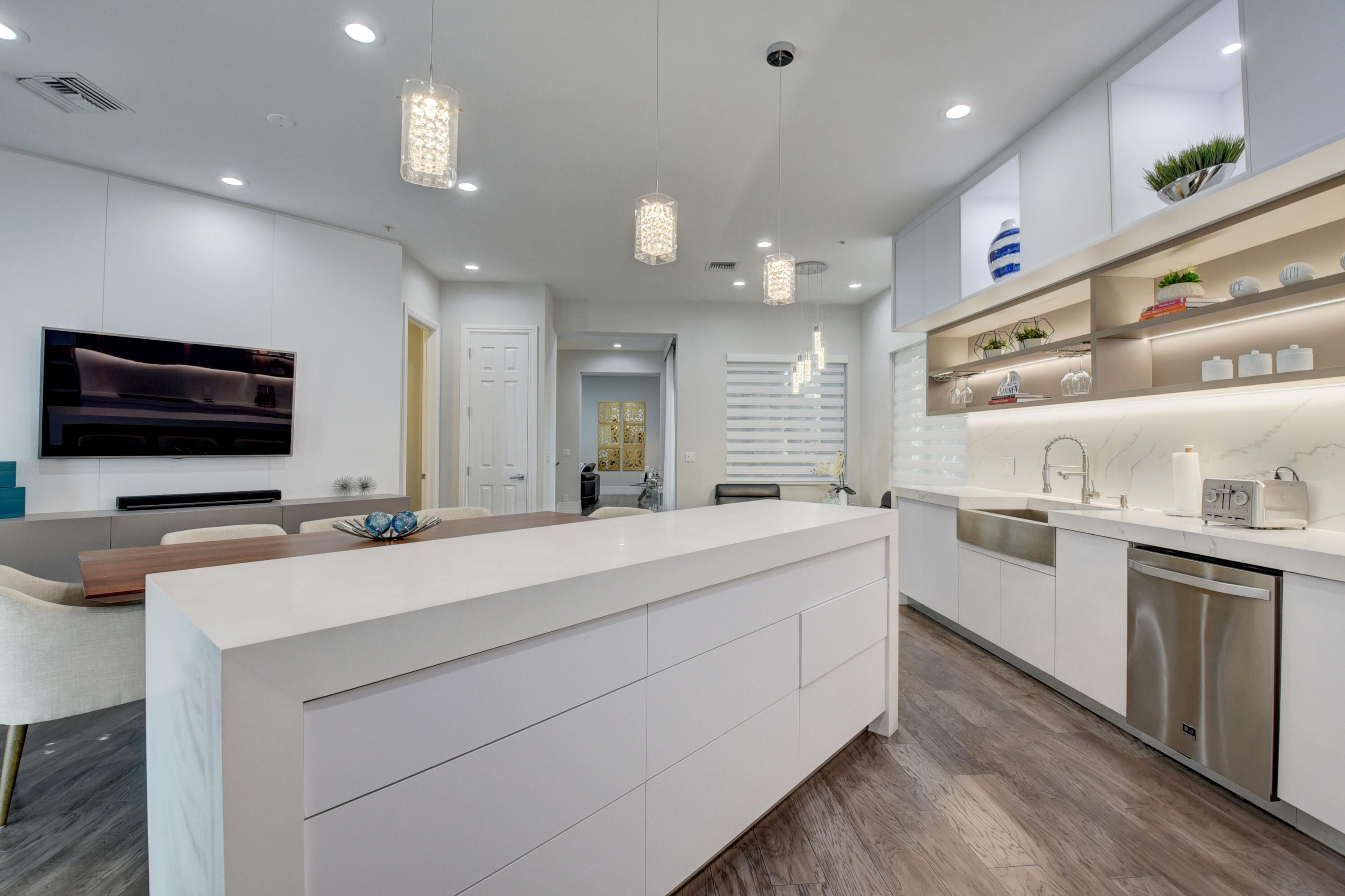 921 Osceola Drive, Unit 4 Boca Raton, FL 33432 - Photo 21 of 46 a large white kitchen with stainless steel appliances kitchen island a stove and a sink