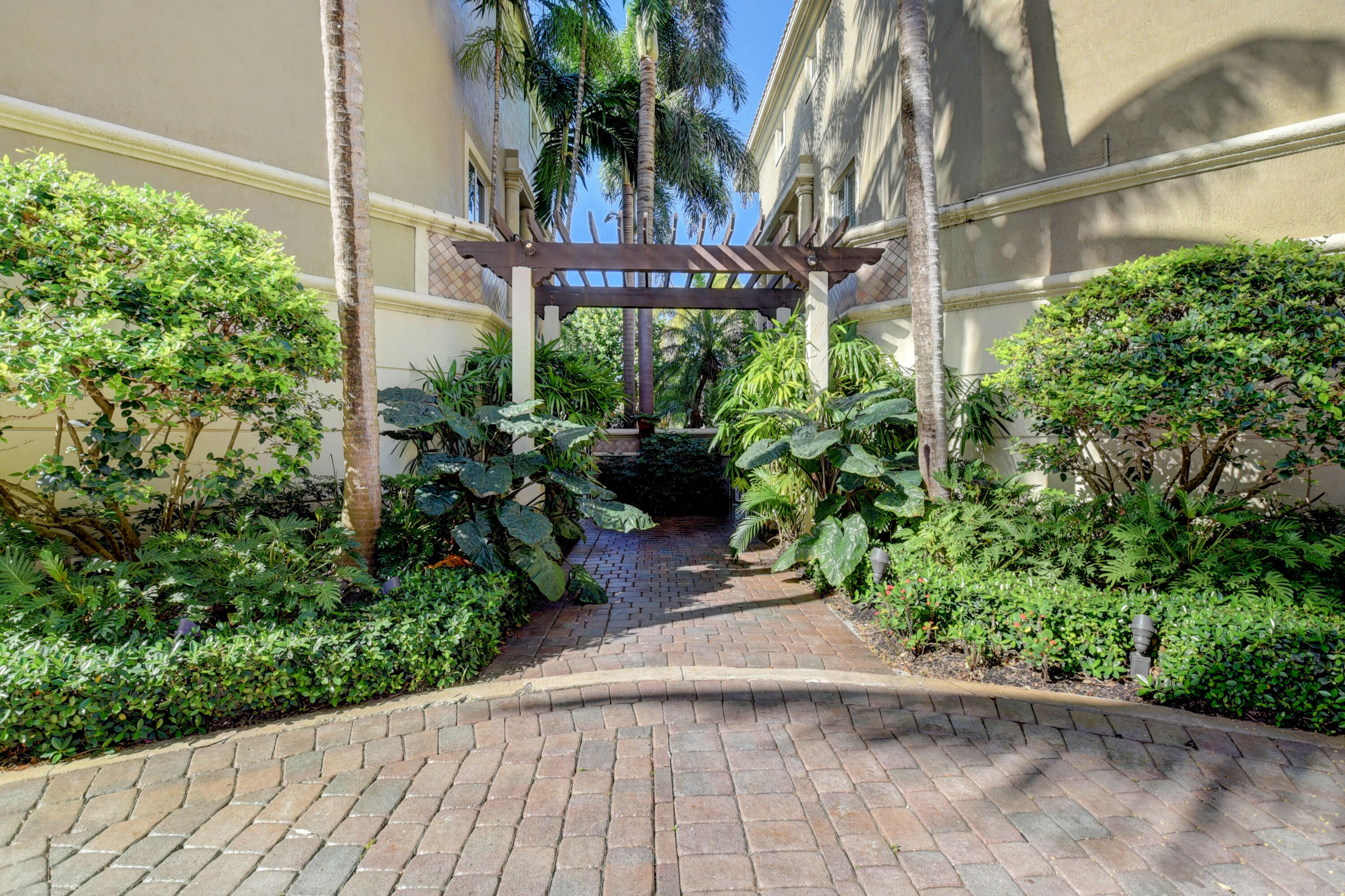 921 Osceola Drive, Unit 4 Boca Raton, FL 33432 - Photo 3 of 46 a couple of flower plants in front of a building