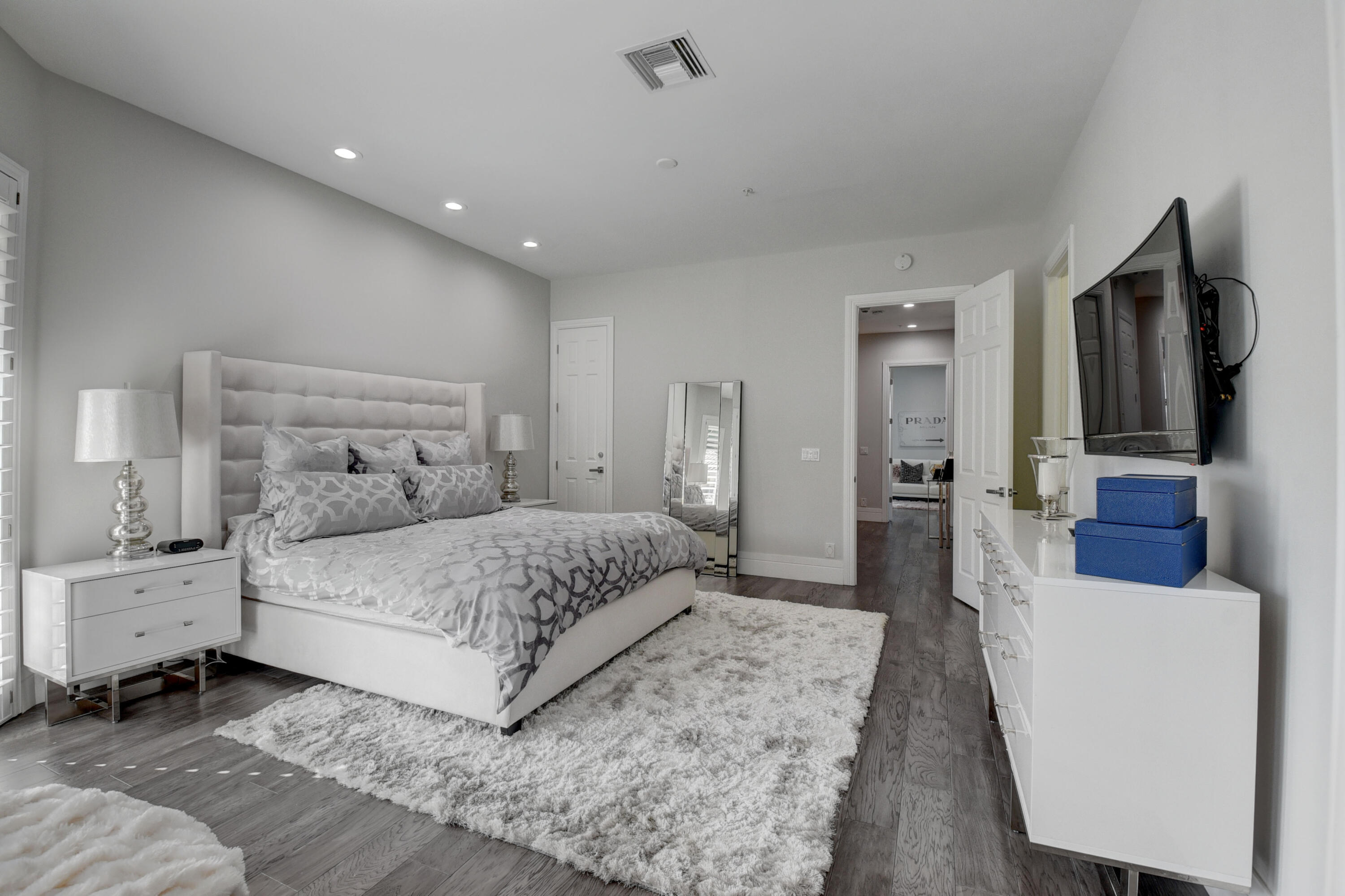 921 Osceola Drive, Unit 4 Boca Raton, FL 33432 - Photo 32 of 46 a bedroom with a bed and a flat screen tv