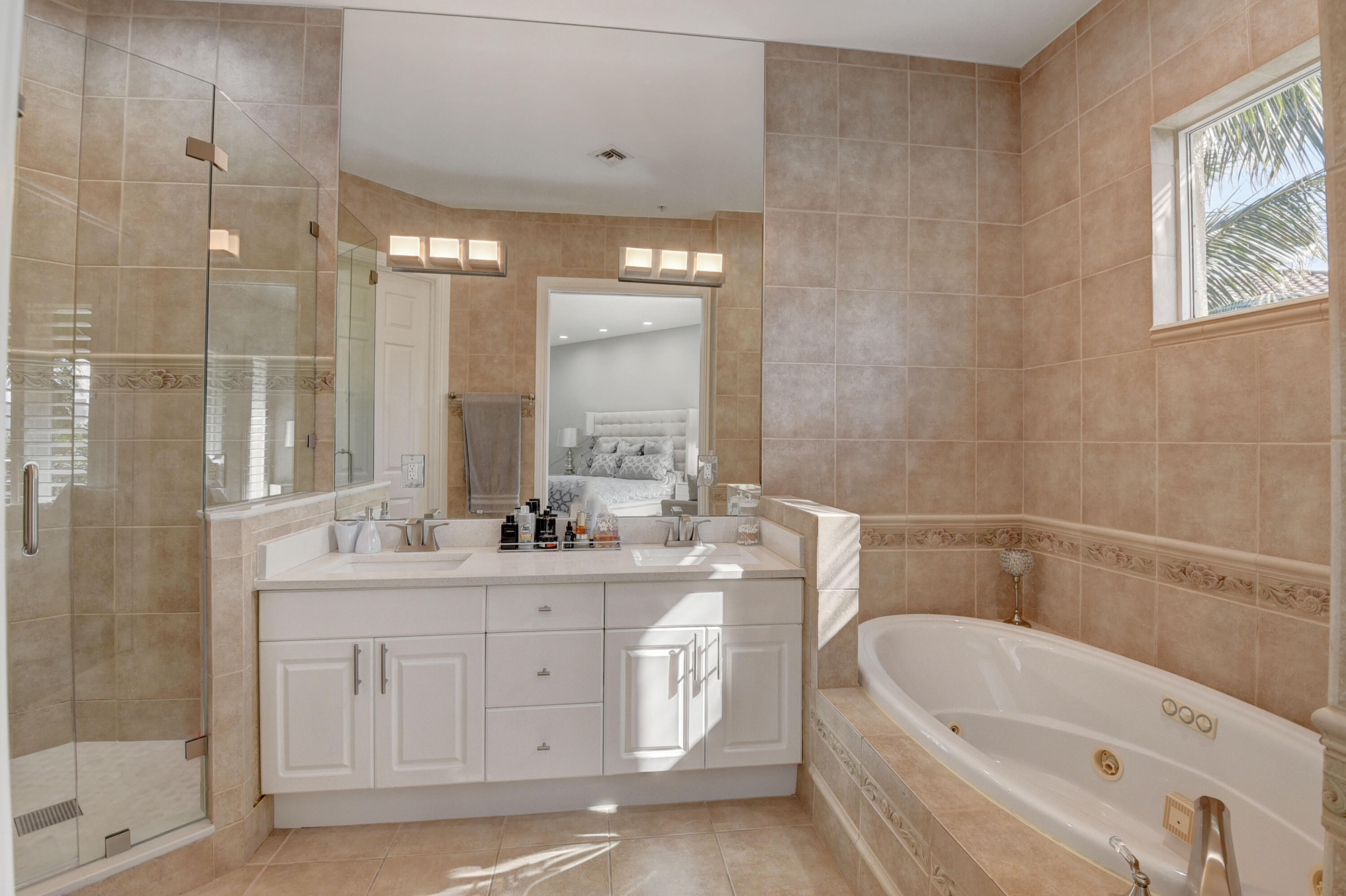 921 Osceola Drive, Unit 4 Boca Raton, FL 33432 - Photo 33 of 46 a bathroom with a double vanity sink a toilet a mirror and shower
