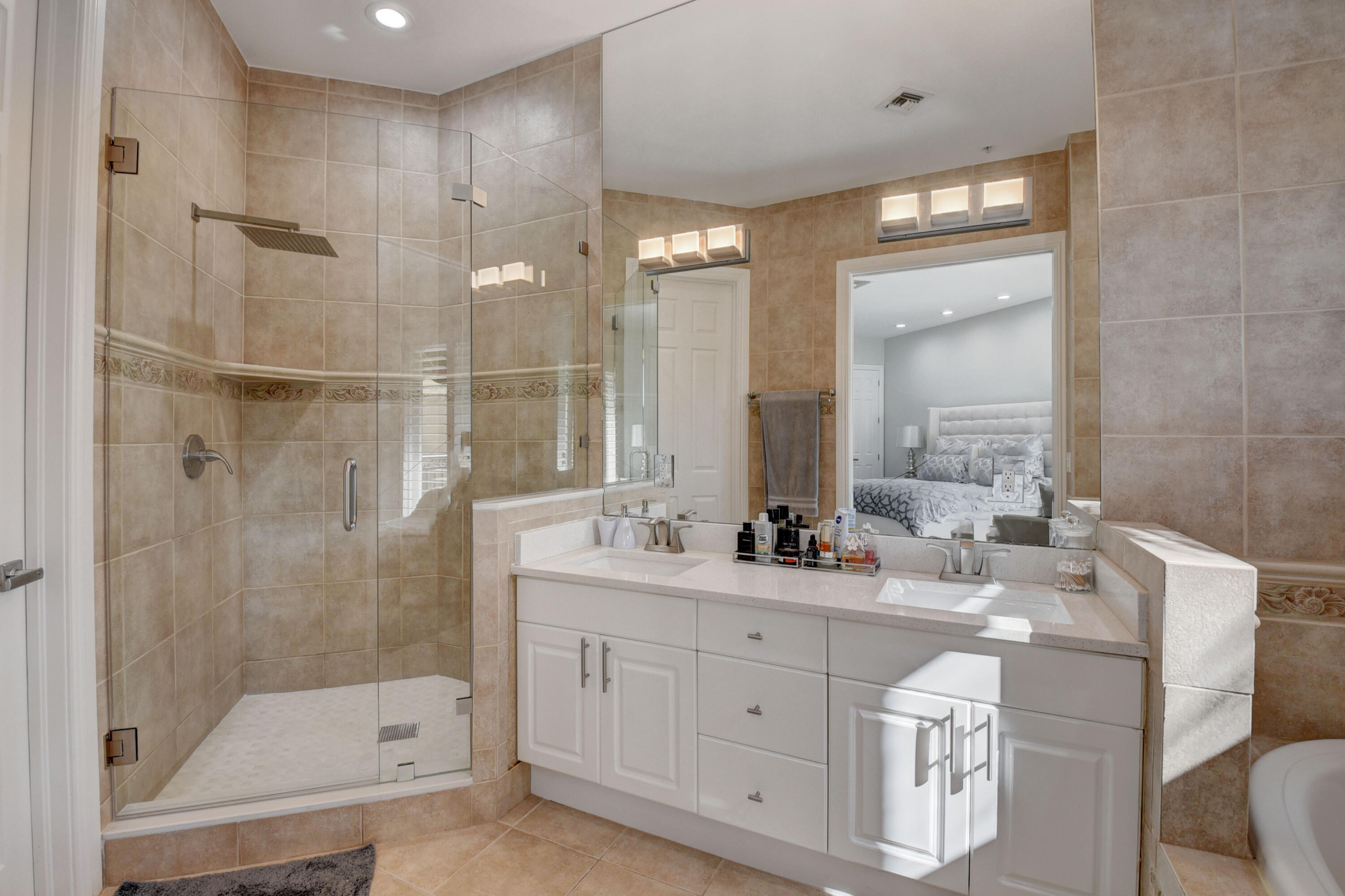 921 Osceola Drive, Unit 4 Boca Raton, FL 33432 - Photo 35 of 46 a bathroom with a double vanity sink mirror and shower