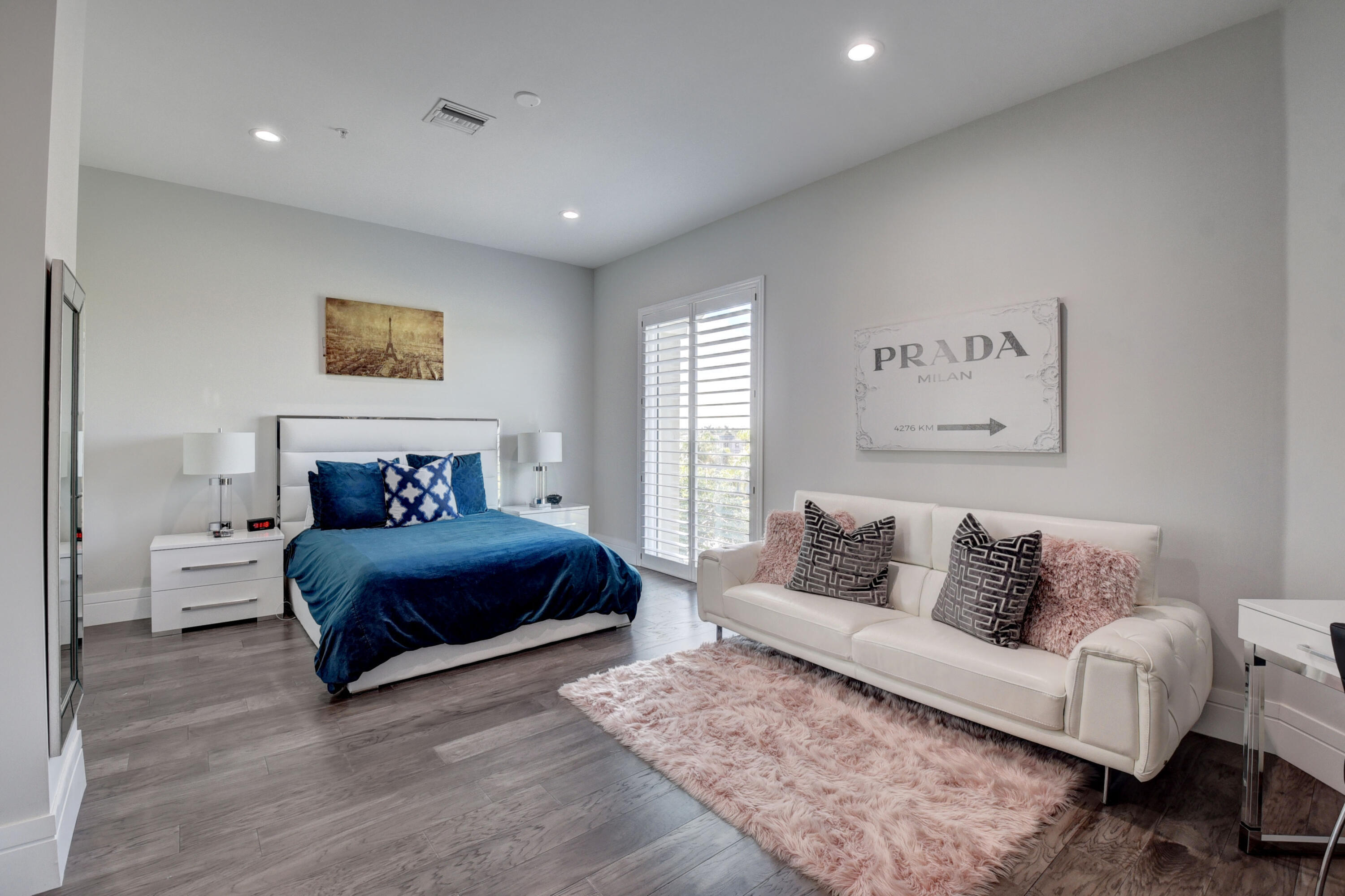 921 Osceola Drive, Unit 4 Boca Raton, FL 33432 - Photo 36 of 46 a spacious bedroom with a bed and a couch