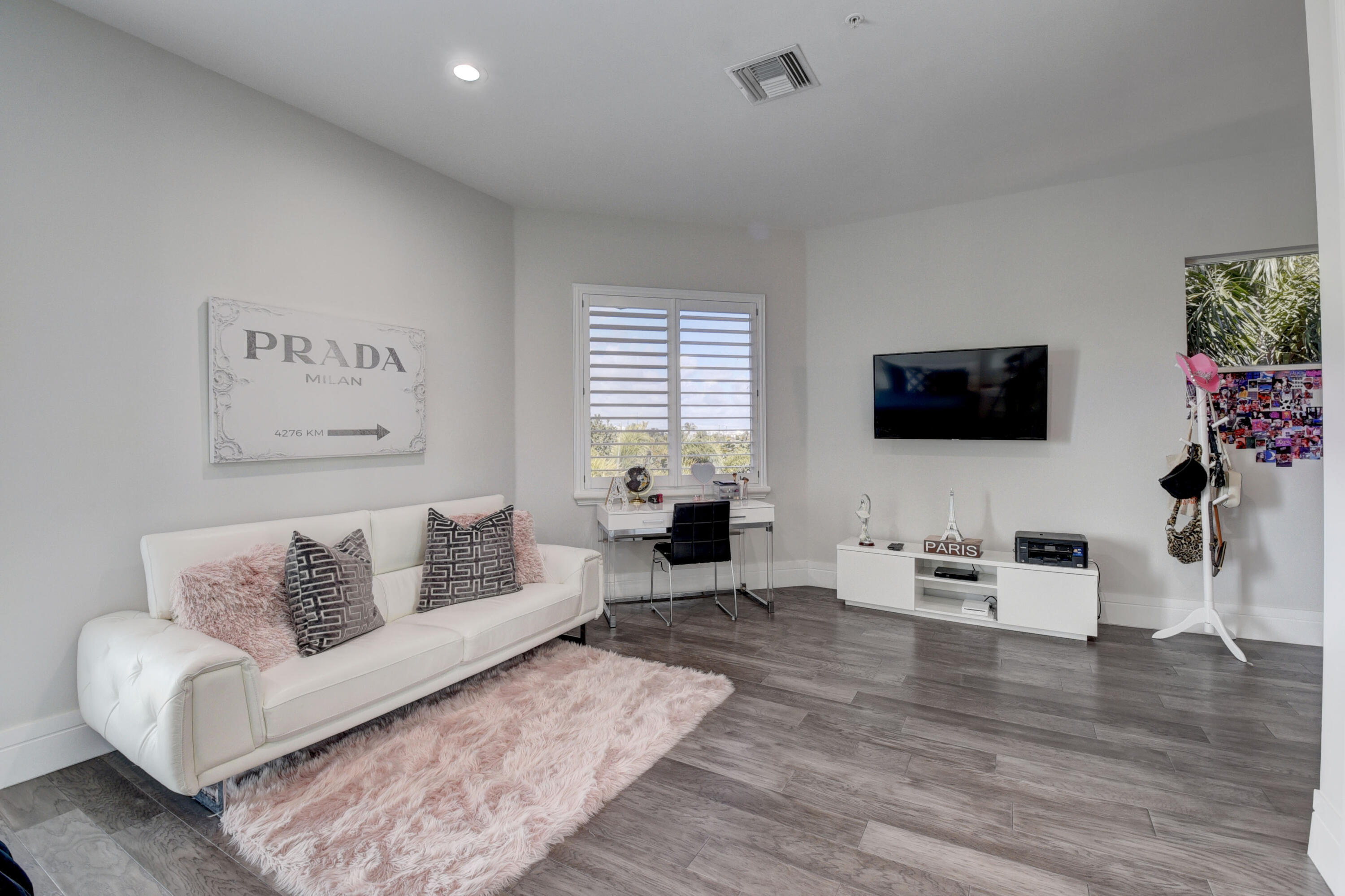 921 Osceola Drive, Unit 4 Boca Raton, FL 33432 - Photo 37 of 46 a living room with furniture and a flat screen tv