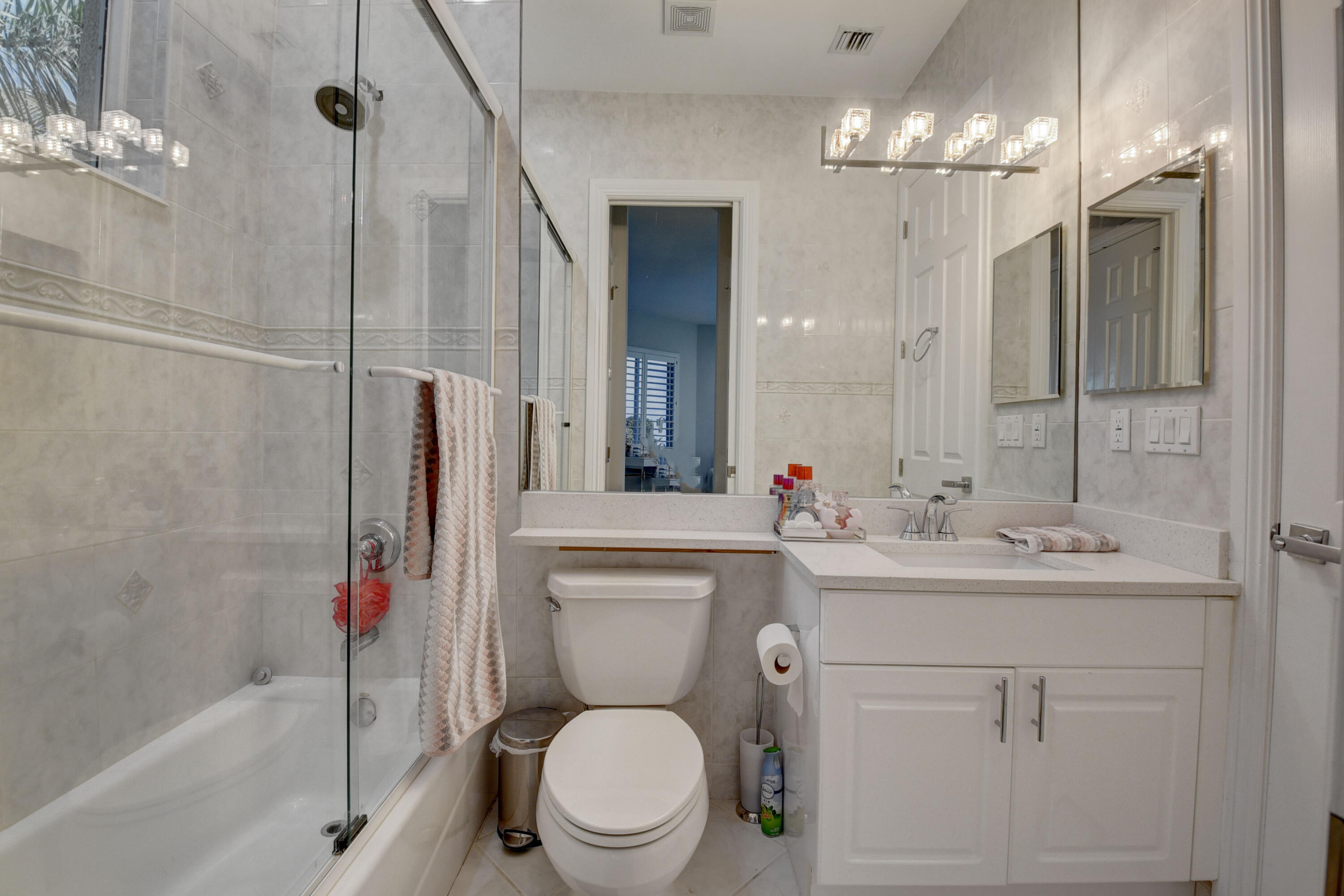 921 Osceola Drive, Unit 4 Boca Raton, FL 33432 - Photo 38 of 46 a bathroom with a toilet sink shower and mirror