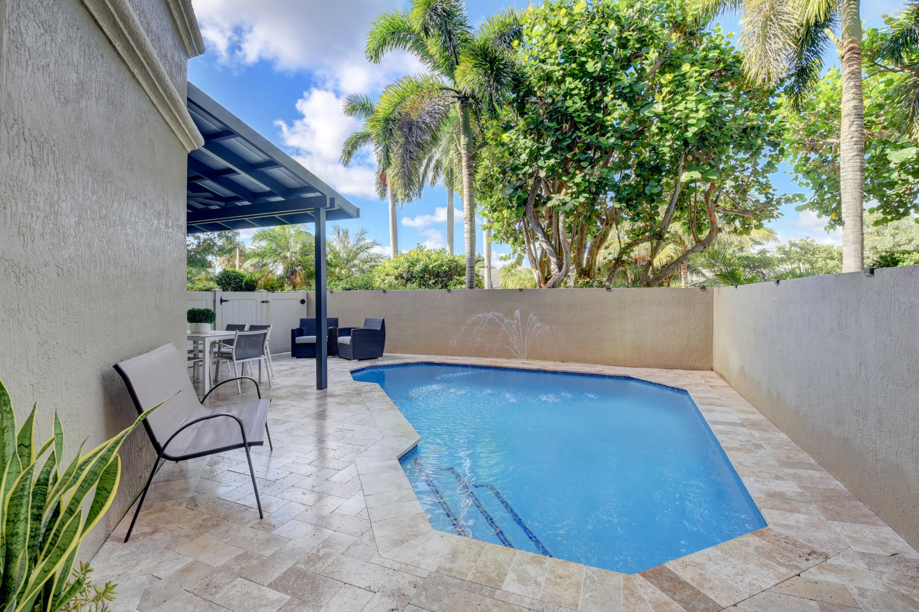 921 Osceola Drive, Unit 4 Boca Raton, FL 33432 - Photo 5 of 46 a view of patio with table and chairs and potted plants