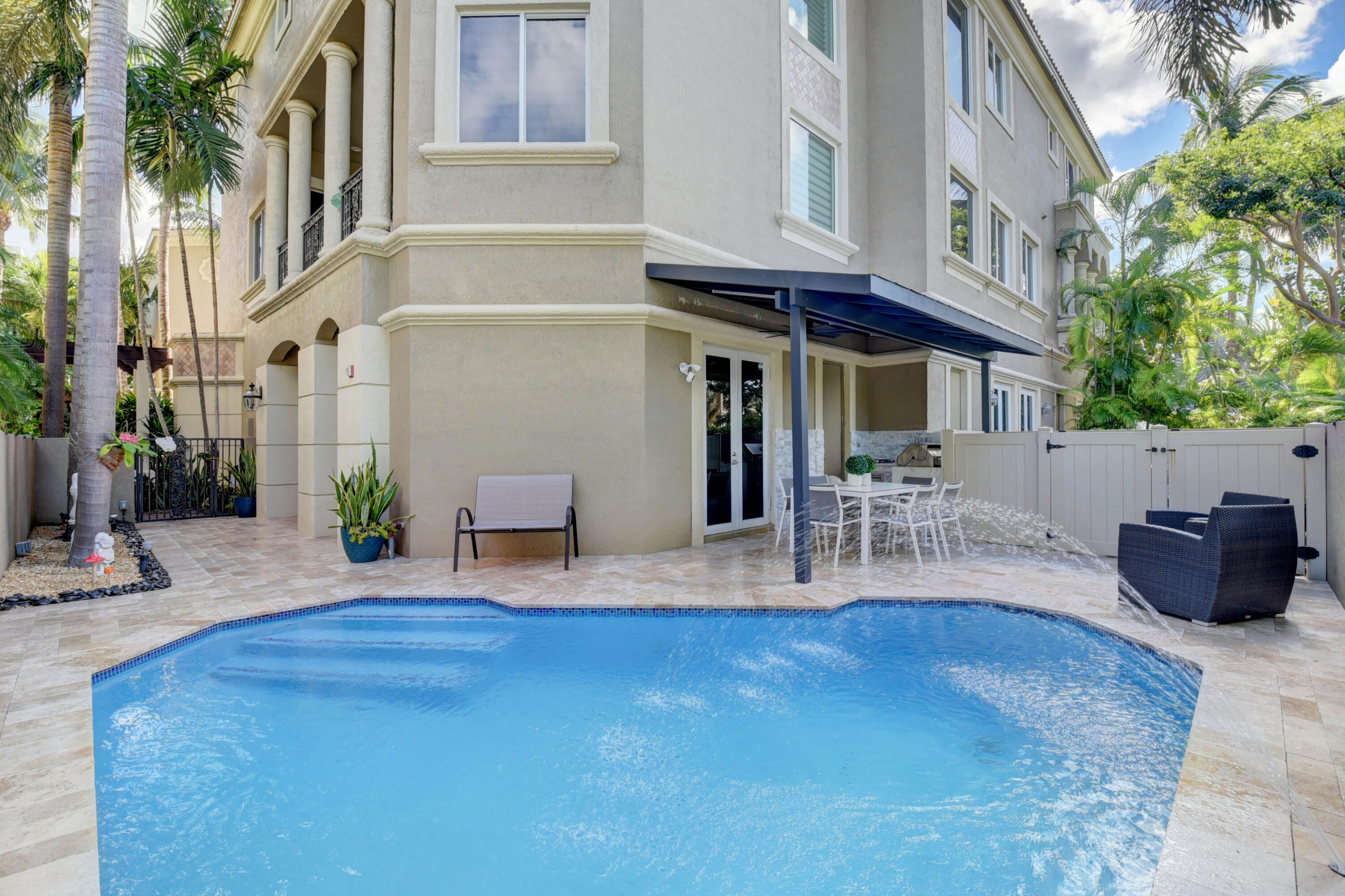 921 Osceola Drive, Unit 4 Boca Raton, FL 33432 - Photo 6 of 46 a view of a chairs and table in the patio
