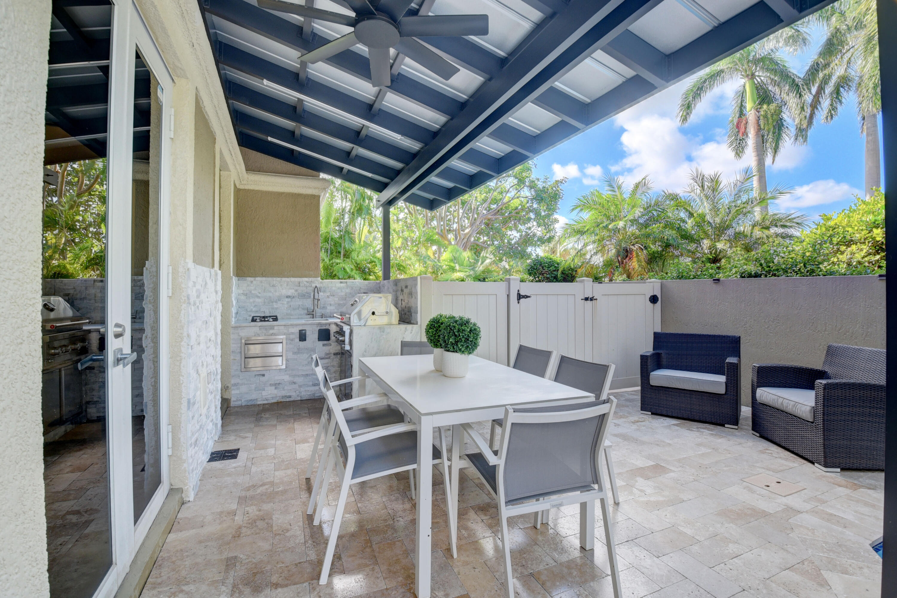 921 Osceola Drive, Unit 4 Boca Raton, FL 33432 - Photo 8 of 46 a view of an outdoor dining space with a table and chairs
