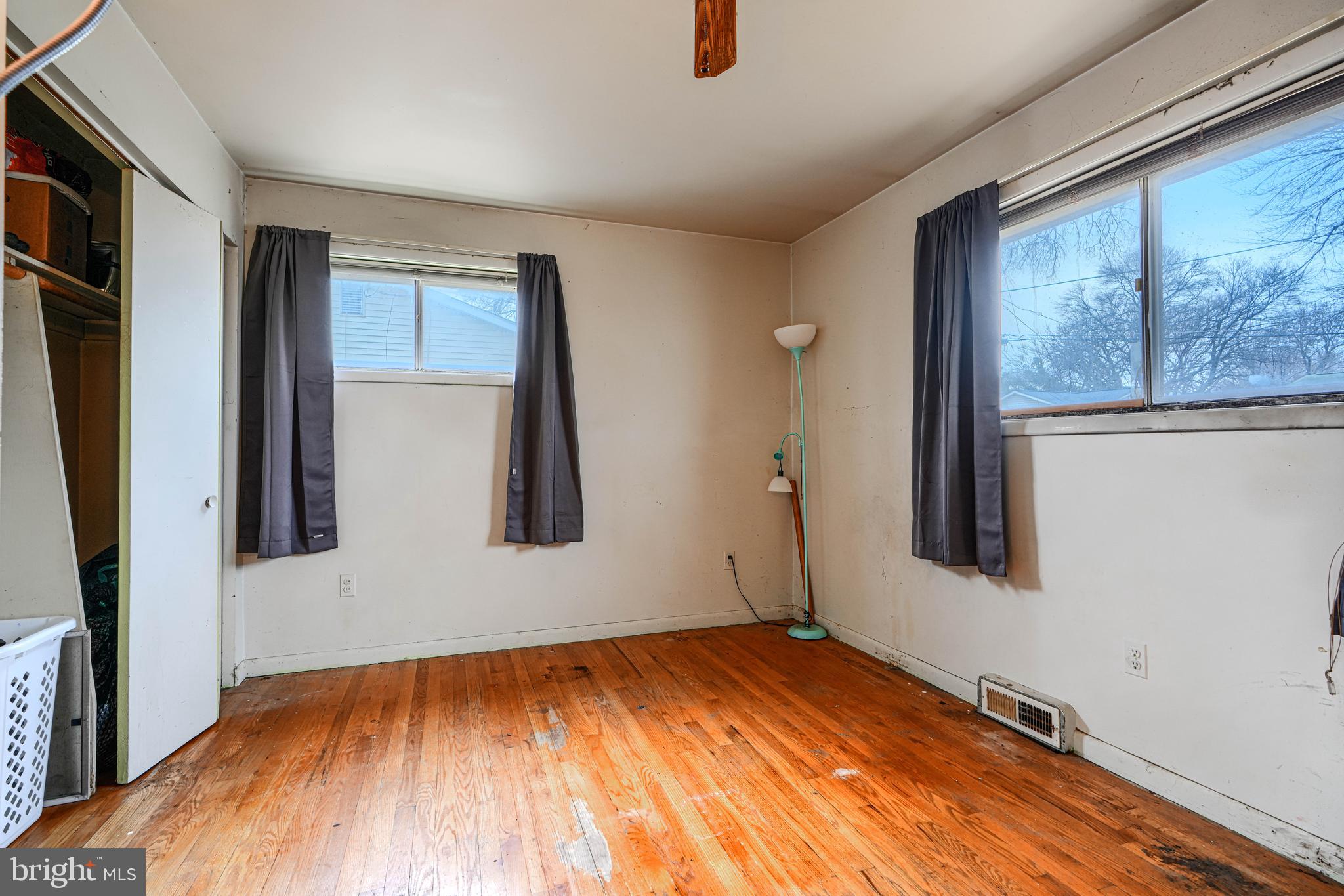 6908 Drylog Street Capitol Heights, MD 20743 - Photo 11 of 38 a view of an empty room with wooden floor and a window