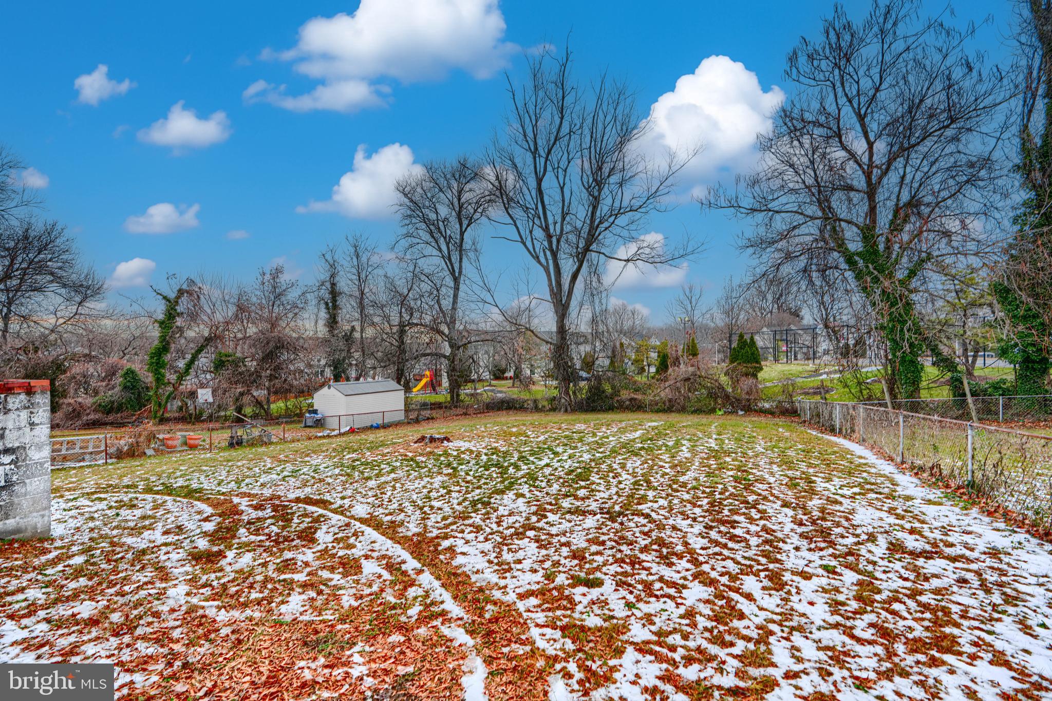 6908 Drylog Street Capitol Heights, MD 20743 - Photo 34 of 38 a view of a yard with snow on the road