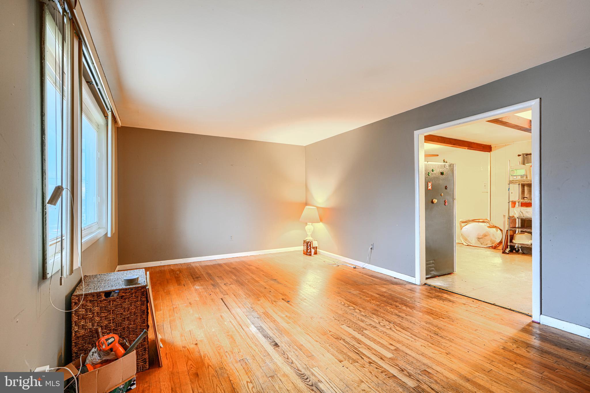6908 Drylog Street Capitol Heights, MD 20743 - Photo 7 of 38 a view of a livingroom with wooden floor and cabinet