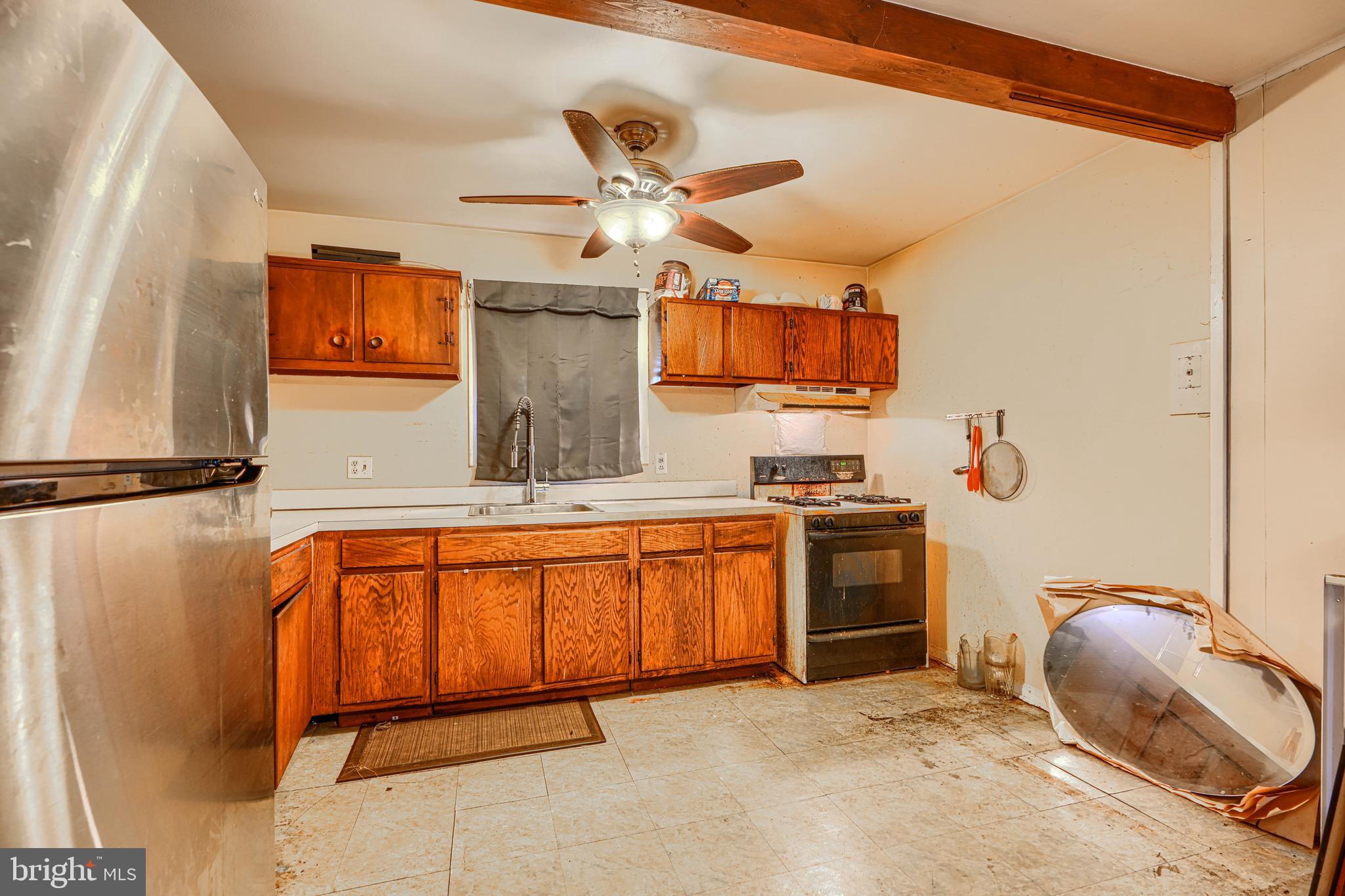 6908 Drylog Street Capitol Heights, MD 20743 - Photo 8 of 38 a kitchen with stainless steel appliances granite countertop a sink and cabinets