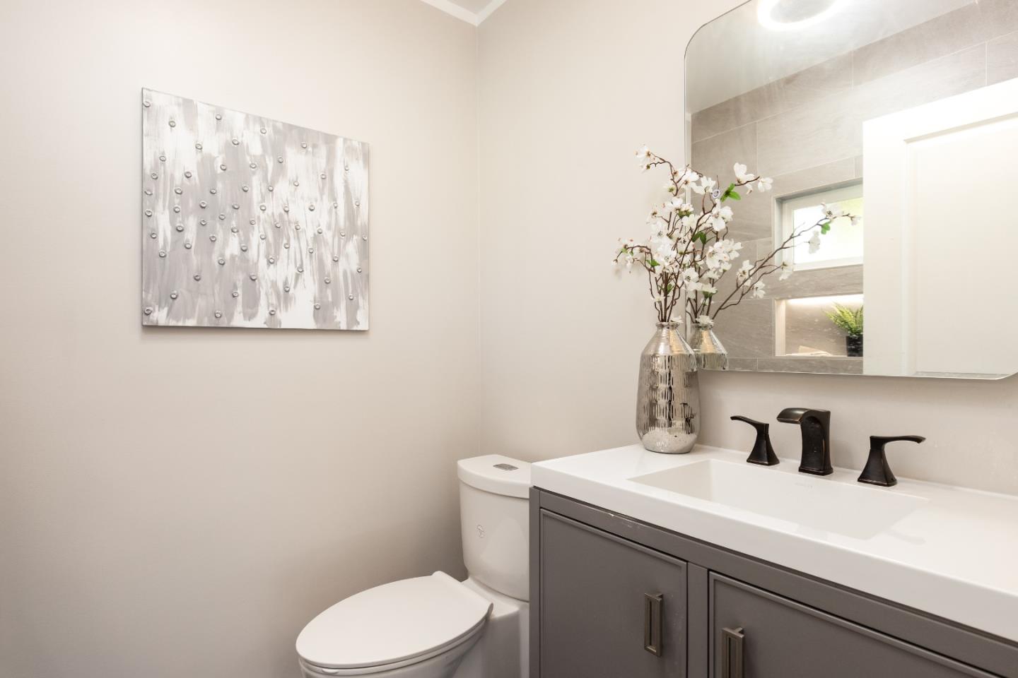 3266 Quandt Road Lafayette, CA 94549 - Photo 22 of 37 a bathroom with a toilet sink and mirror
