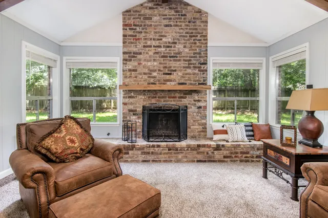 a living room with furniture and a fireplace