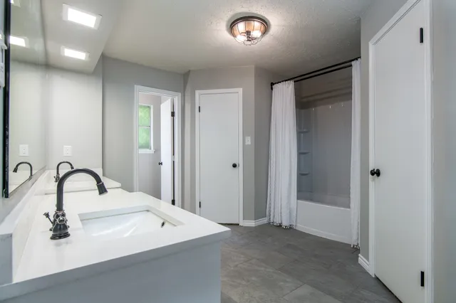 a bathroom with a sink and mirror
