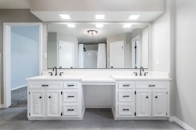 a spacious bathroom with a double vanity sink double and mirror