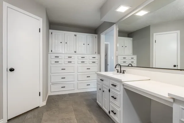 a kitchen with cabinets appliances and a sink