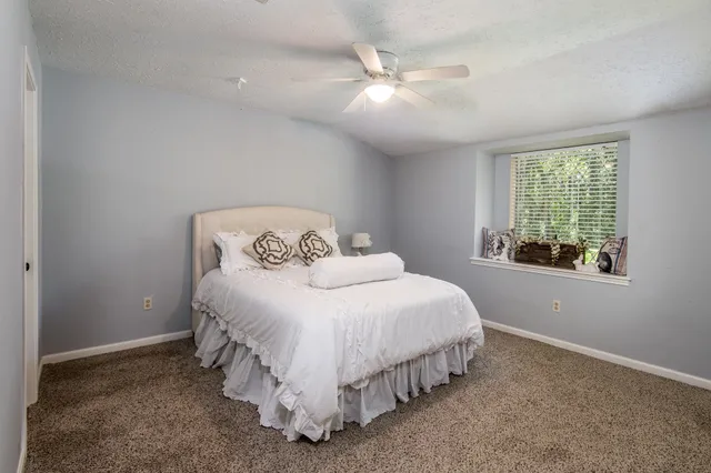 a bedroom with a bed and window