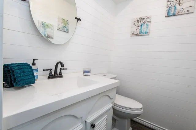 a bathroom with a sink a mirror and toilet