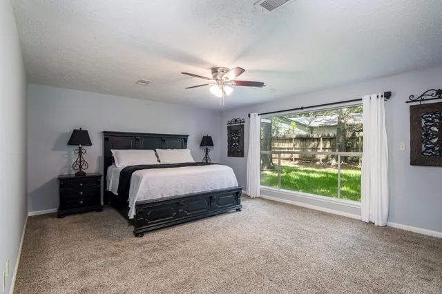 a bed sitting in a bedroom next to a window