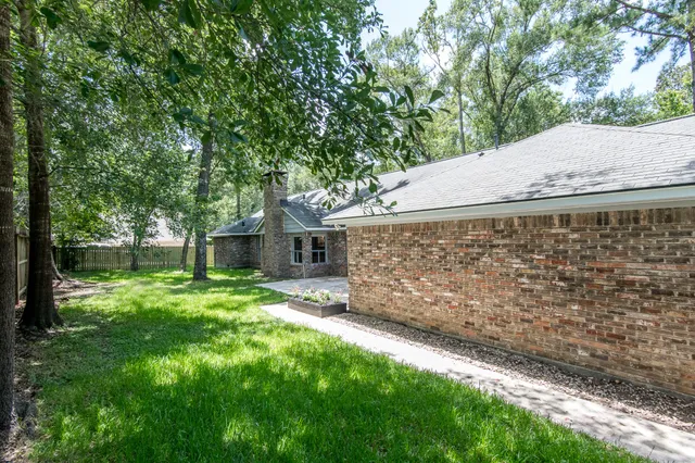 a view of a house with a large tree