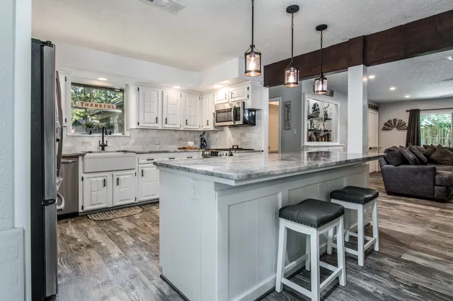 a kitchen with a sink cabinets and window