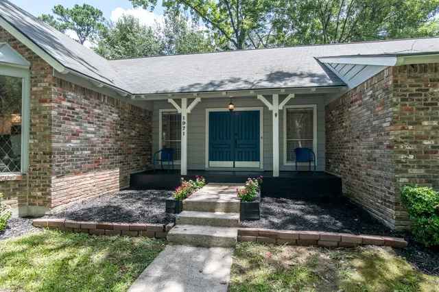 a front view of a house with garden