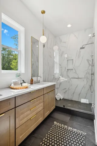 a bathroom with a sink toilet and mirror