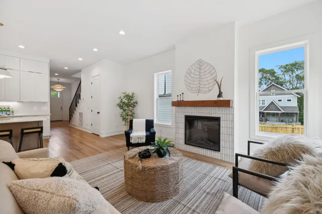 a kitchen with stainless steel appliances a refrigerator a sink a stove a dining table and chairs