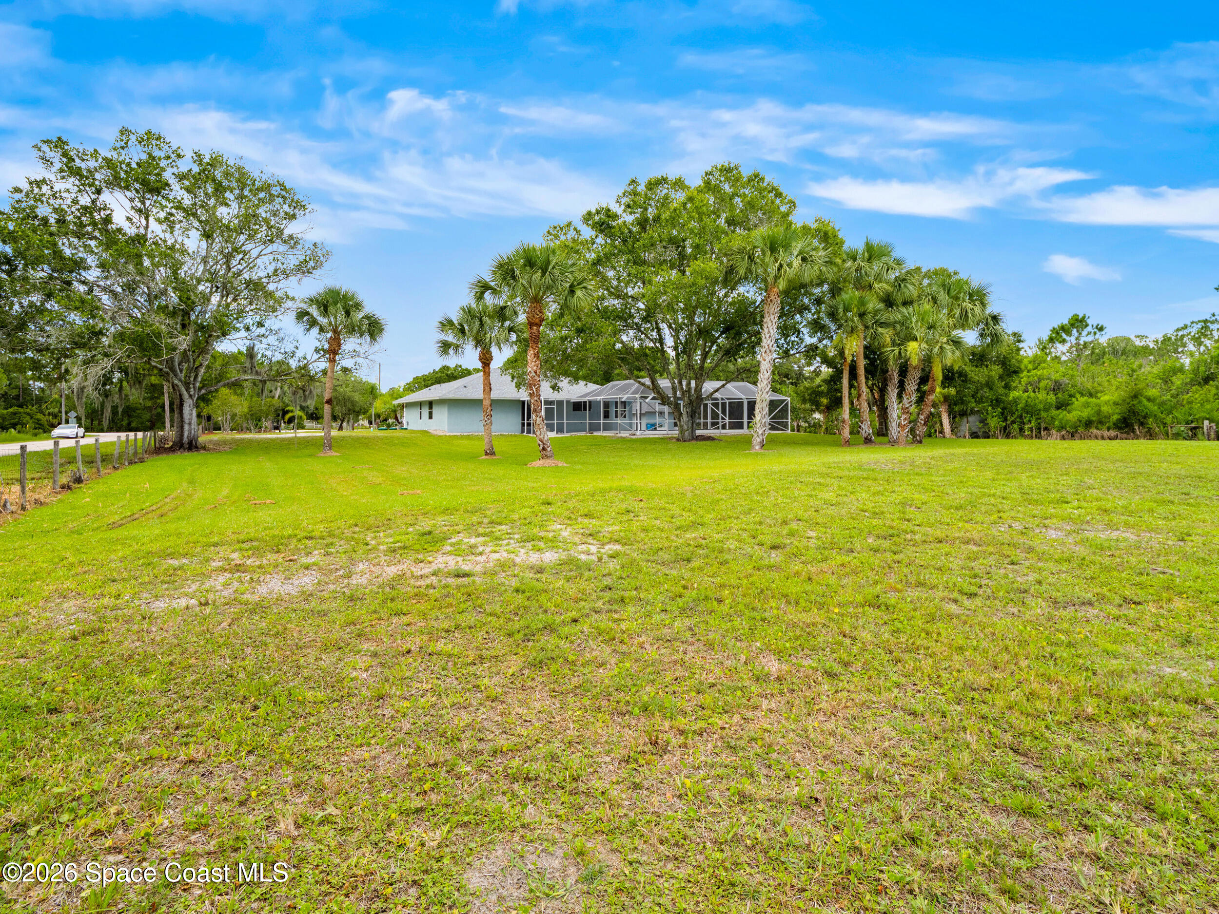 3480 Weber Road Malabar, FL 32950 - Photo 29 of 45 a view of a green yard next to a building