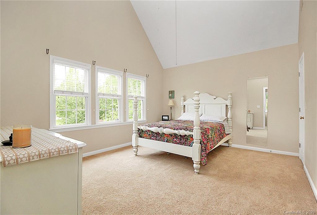 2601 Walker Road Matthews, NC 28105 - Photo 22 of 48 a bed sitting in a spacious bedroom next to a window