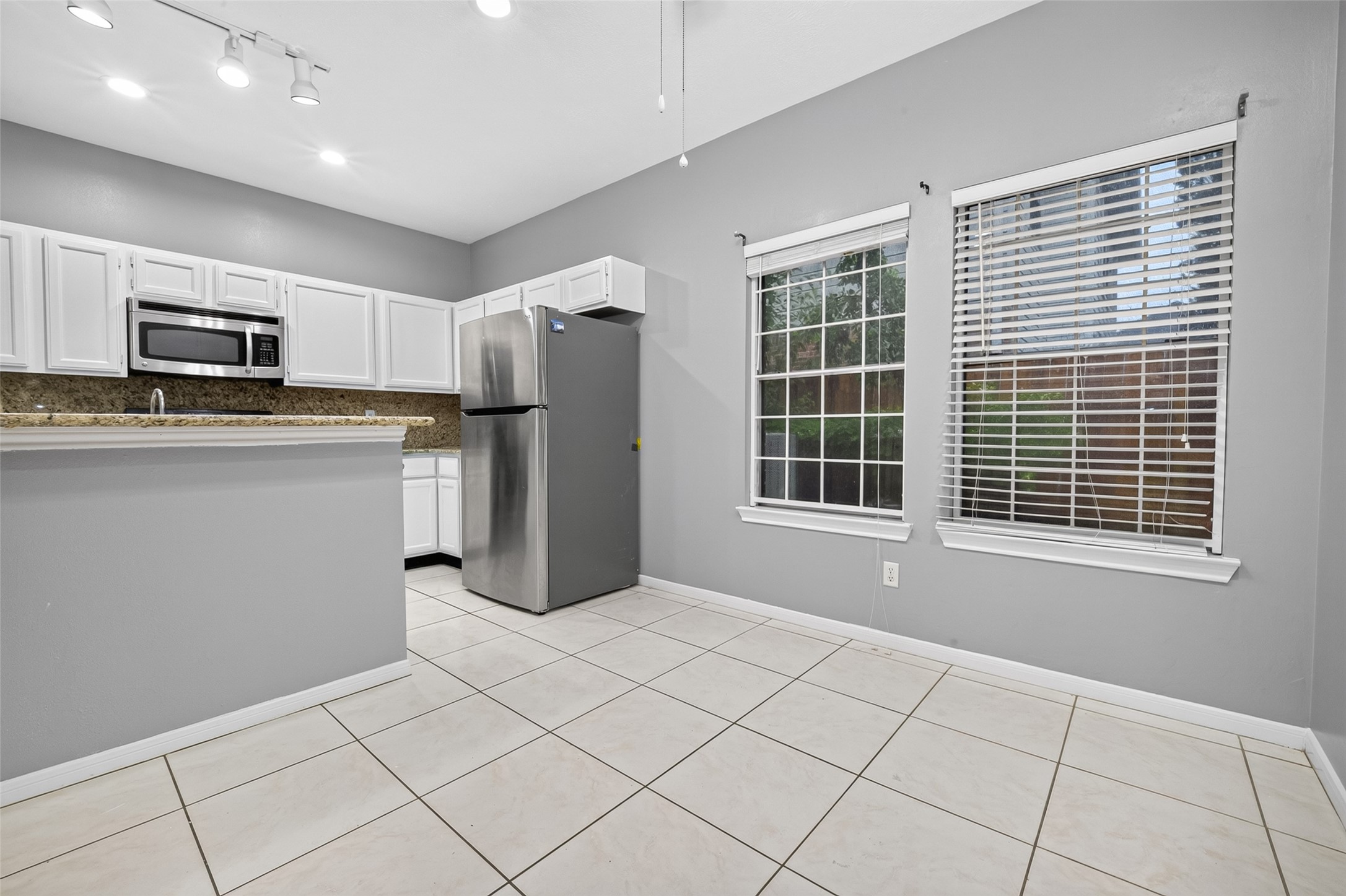 13607 Sable Lane Houston, TX 77014 - Photo 20 of 46 a kitchen with stainless steel appliances a refrigerator and a stove top oven