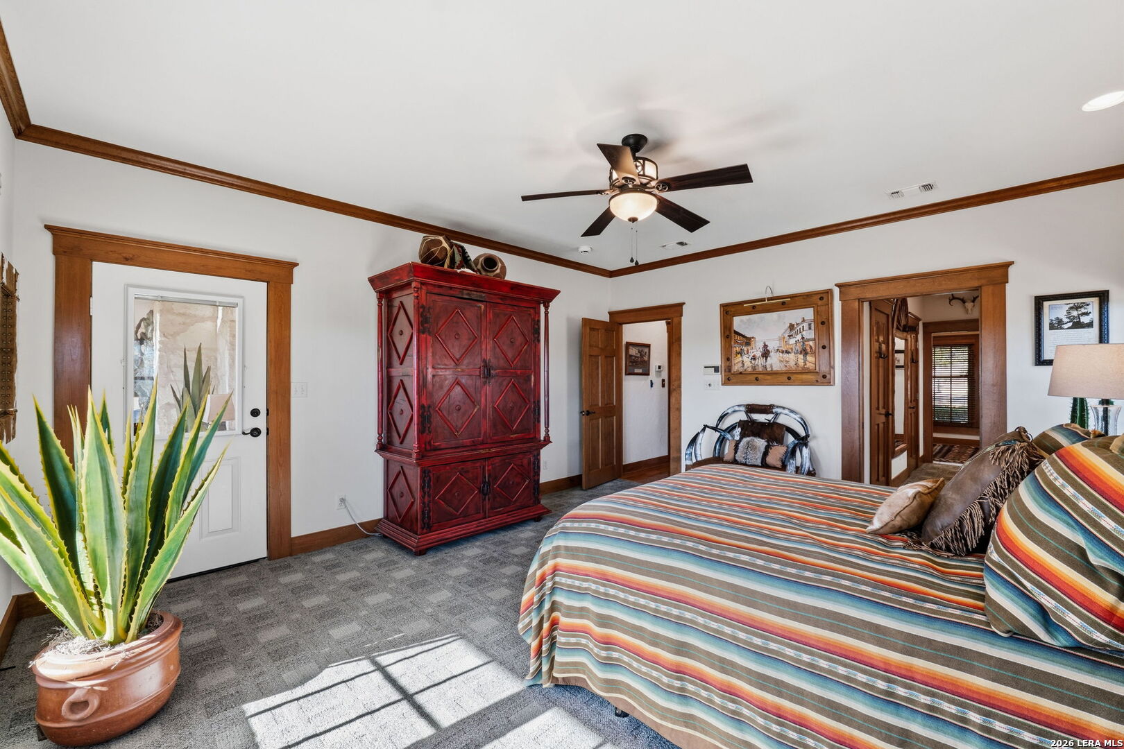 521 Bluff Creek Road North Center Point, TX 78010 - Photo 23 of 74 a bedroom with a bed a dresser and potted plants
