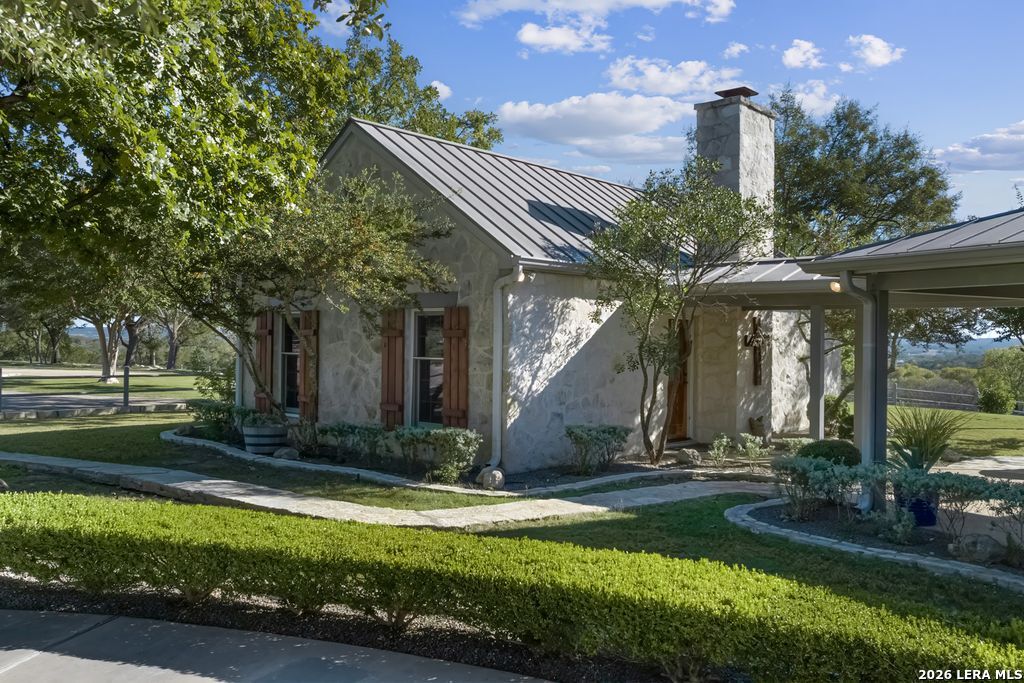 521 Bluff Creek Road North Center Point, TX 78010 - Photo 27 of 74 a front view of a house with garden