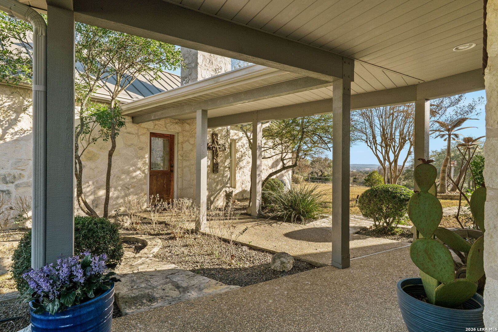 521 Bluff Creek Road North Center Point, TX 78010 - Photo 28 of 74 a view of a porch with chairs and floor to ceiling window