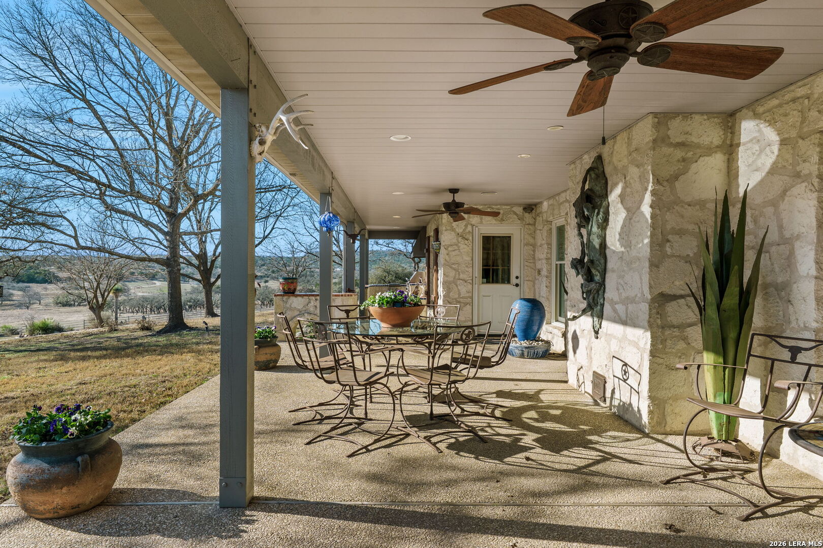 521 Bluff Creek Road North Center Point, TX 78010 - Photo 47 of 74 a view of a patio with table and chairs potted plants