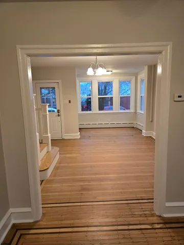 a view of an entryway with wooden floor