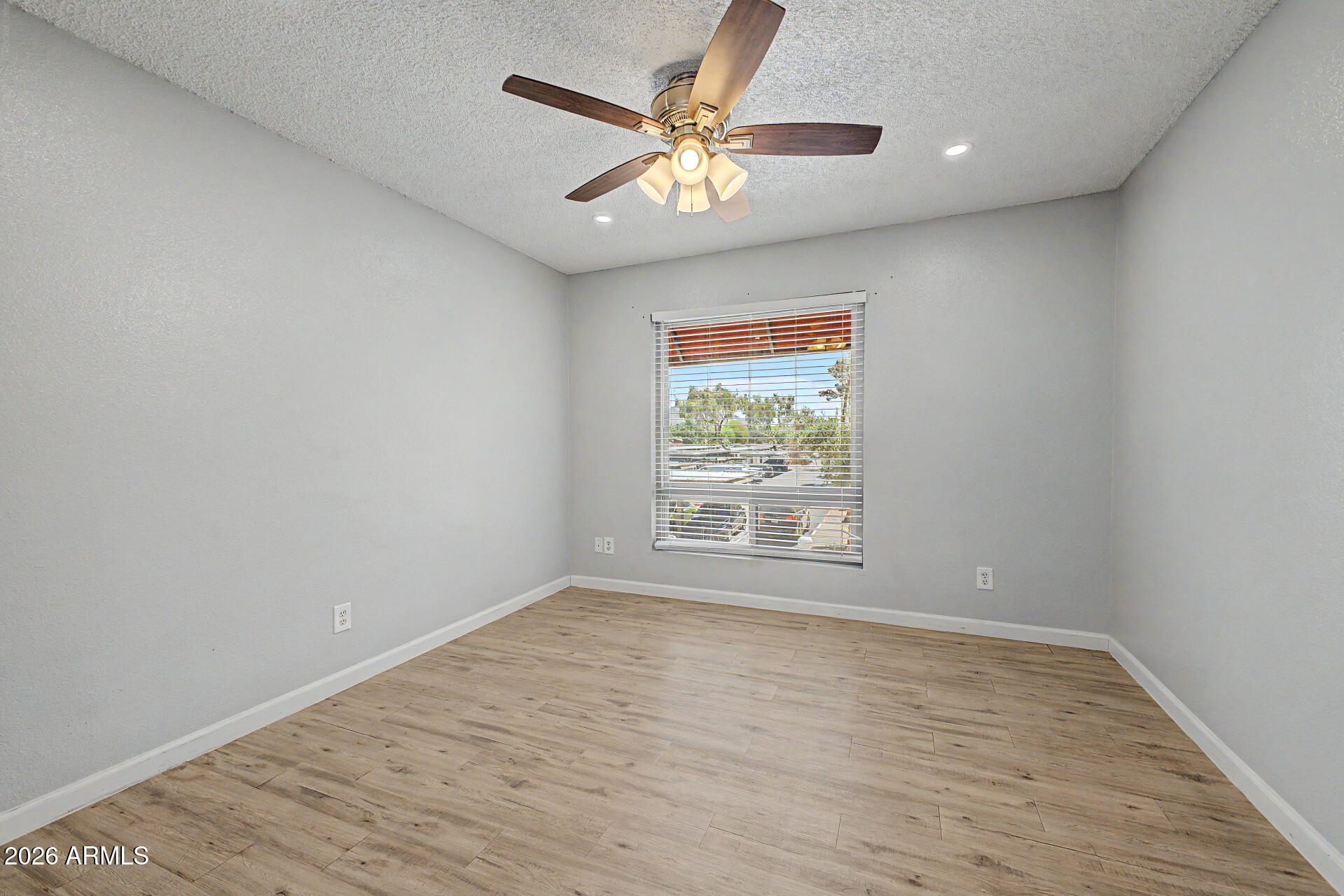 2625 East Indian School Road, Unit 227 Phoenix, AZ 85016 - Photo 13 of 31 wooden floor in an empty room with a window