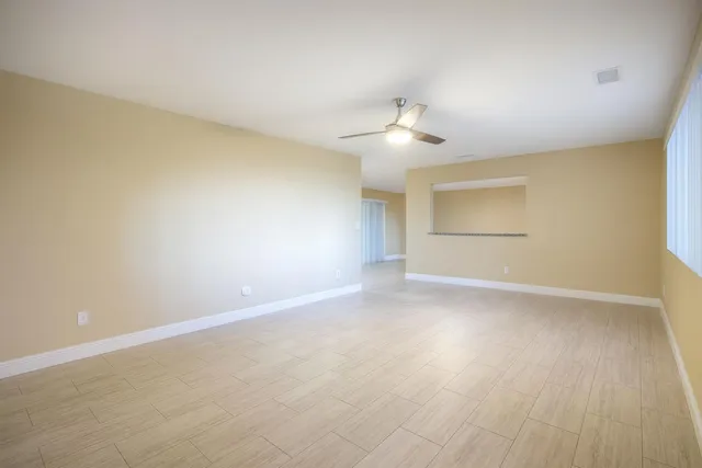 an empty room with a empty space and a ceiling fan