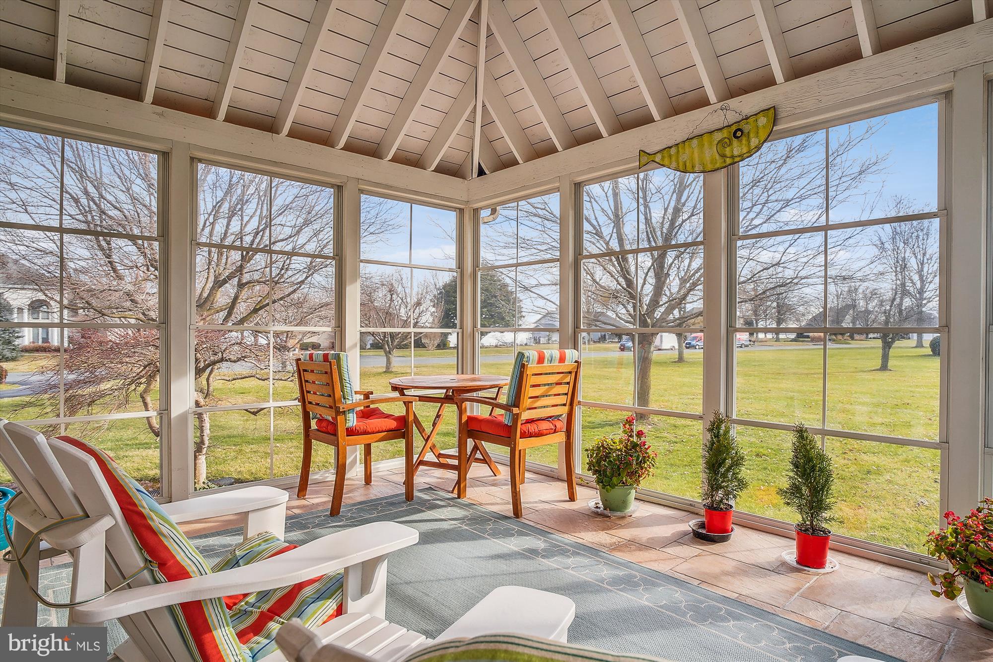 2802 Cox Neck Road Chester, MD 21619 - Photo 8 of 55 a living room with large windows and a table