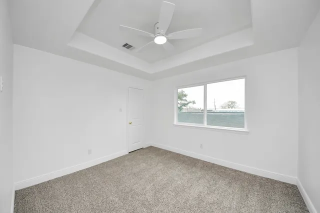front view of house with a yard and potted plants