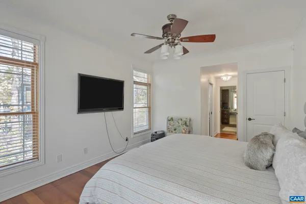 a bedroom with bed and a potted plant