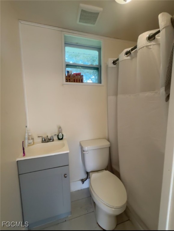 716 Pondella Road Fort Myers, FL 33903 - Photo 2 of 4 a white toilet sitting next to a bathroom sink