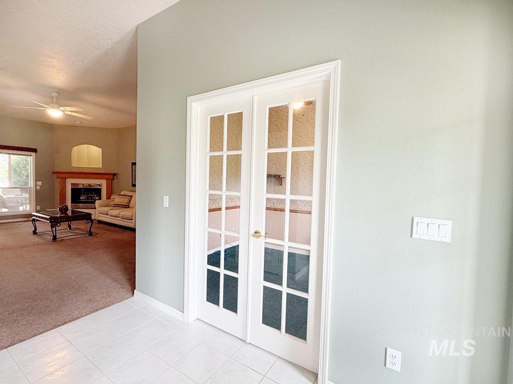 5875 Diamond Ridge Way Nampa, ID 83686 - Photo 9 of 32 Elegant double French doors with multi-pane glass panels and white trim frame the entry to this bright, open living space