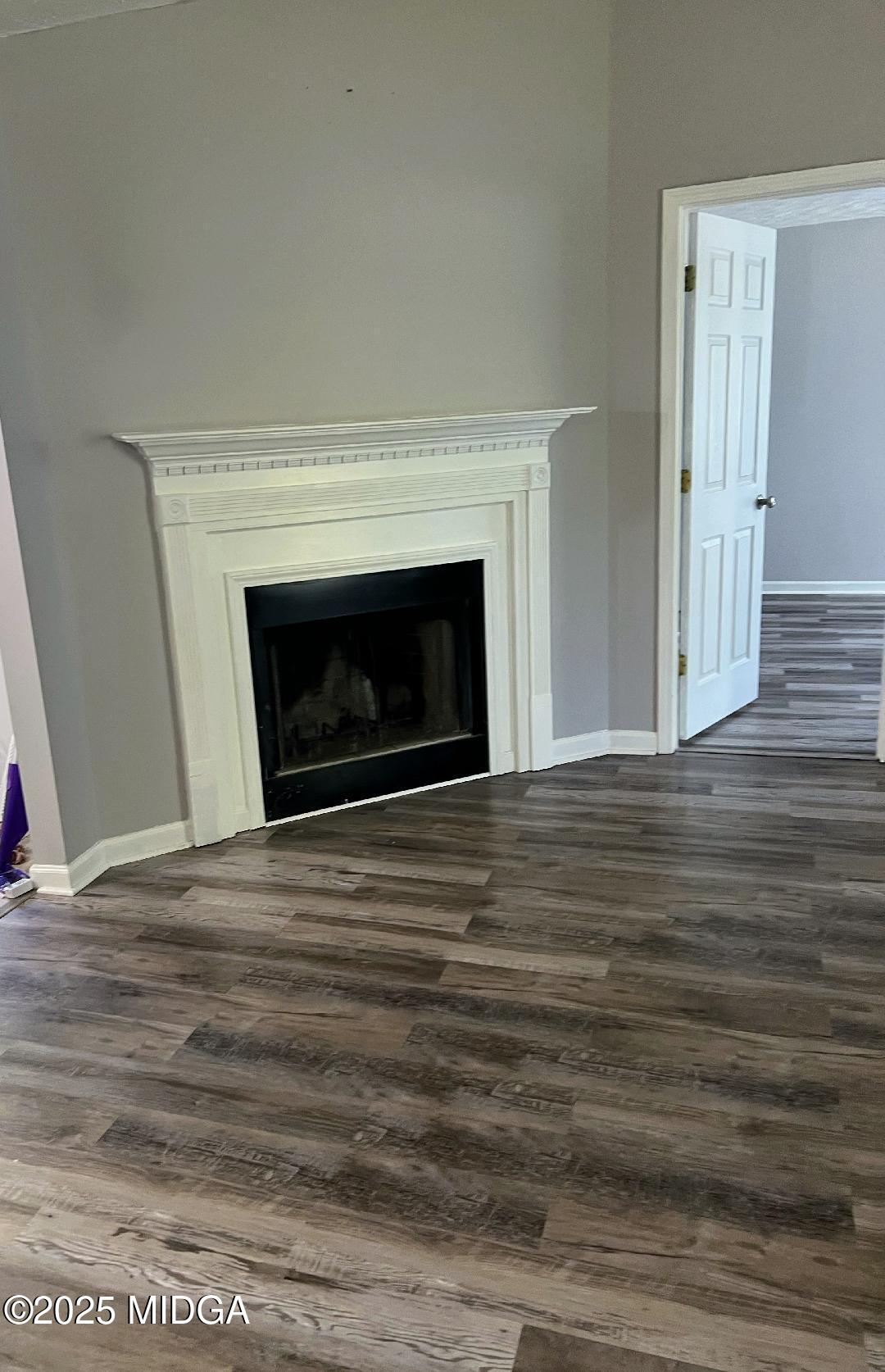 198 Apple Valley Road Macon, GA 31217 - Photo 3 of 12 a view of empty room with wooden floor and fireplace