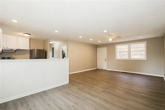 a view of kitchen with kitchen island wooden floor center island and stainless steel appliances with wooden floor
