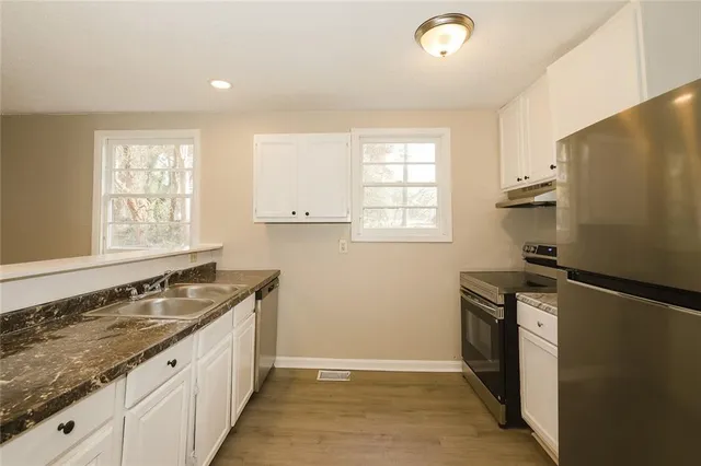 a kitchen that has a sink and a stove