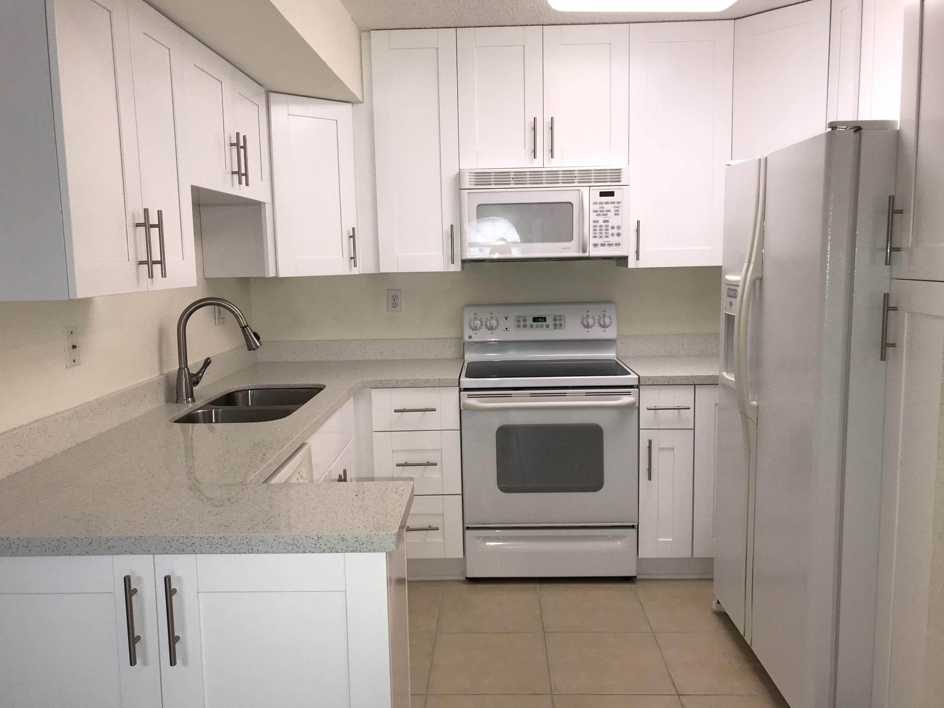 8249 Thames Boulevard, Unit B Boca Raton, FL 33433 - Photo 1 of 46 a kitchen with appliances a sink and cabinets