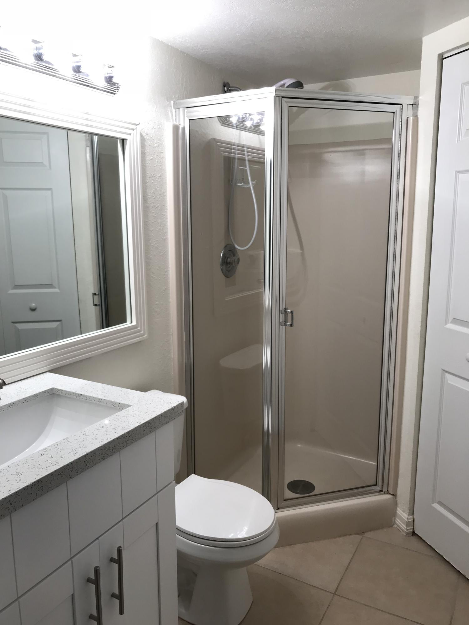 8249 Thames Boulevard, Unit B Boca Raton, FL 33433 - Photo 12 of 46 a bathroom with a shower a toilet and sink